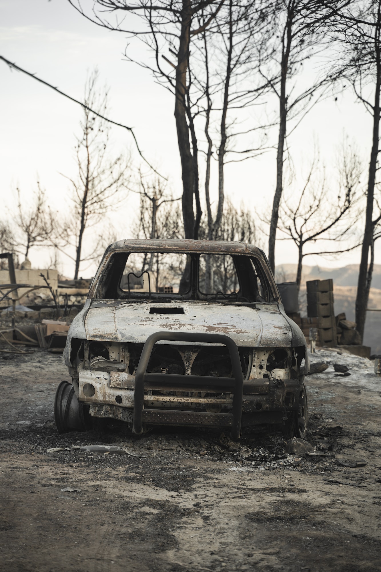 Burnt car aftermath forest fire consequence of climate change - Wildfire Crisis and Global Collapse